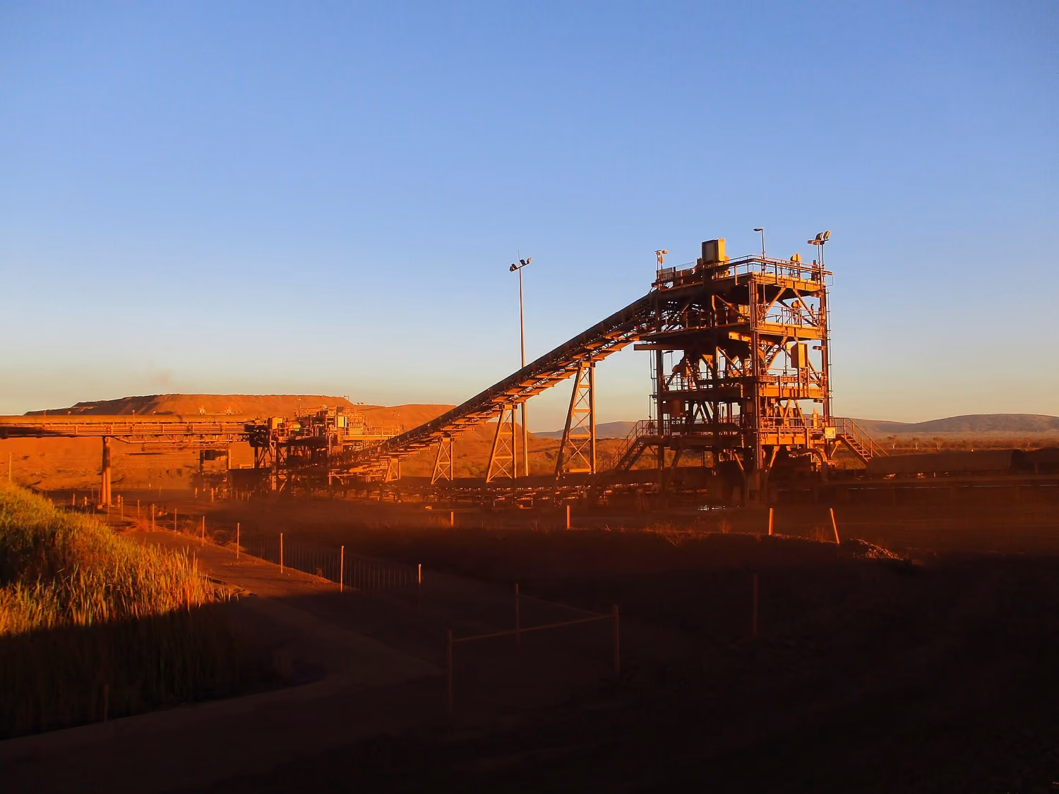 Ore processing plant and conveyor at golden hour