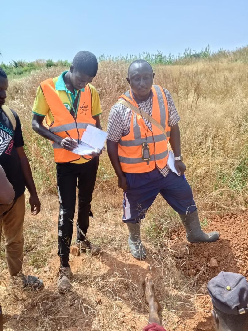 Site supervisor and field assistant recording pit observations on location.