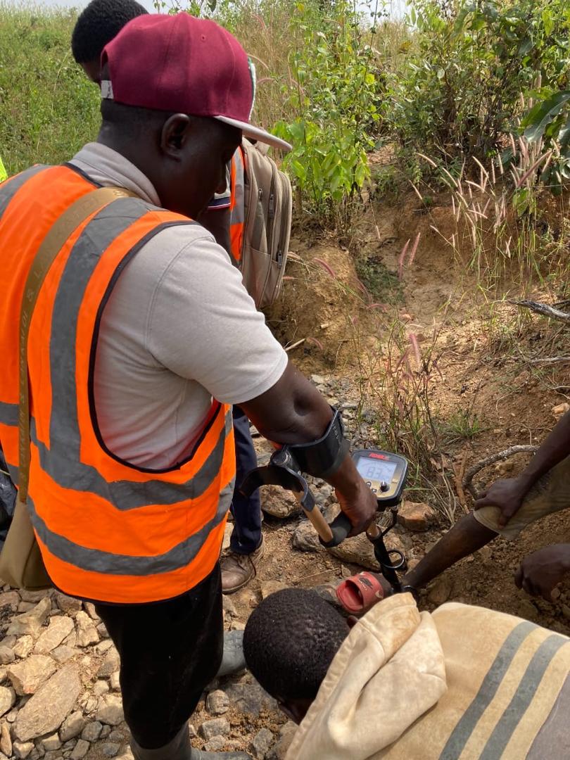 Detector sweep along an exposed cut, checking for mineralised ground.